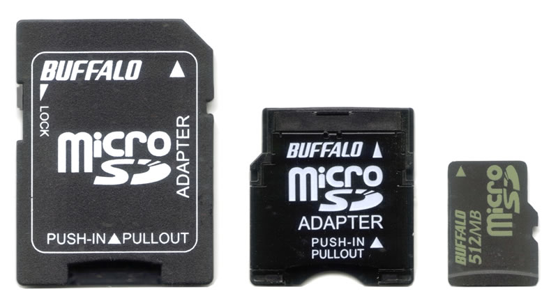 A 512 MB microSD memory card beside a full-sized SD adapter